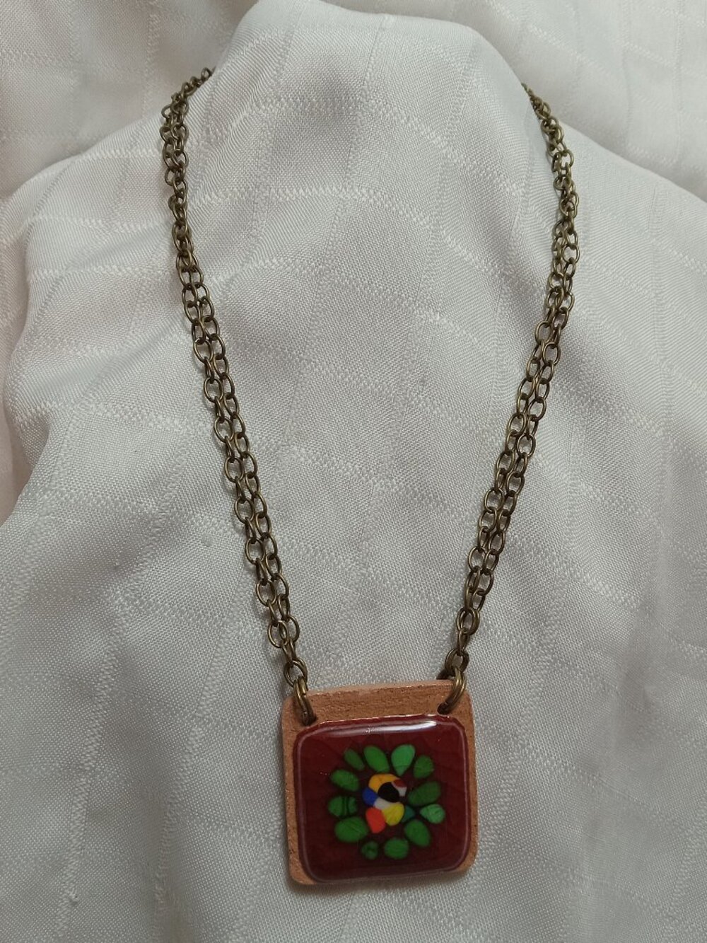 Handmade necklace crafted by an artist specializing in ceramics and glass
